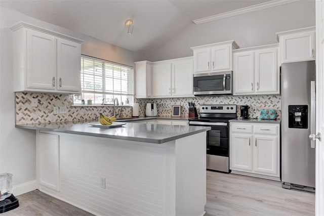 2333 Berry Ln, Midwest City, OK 73130 - kitchen with stainless steel appliances, white cabinets, light wood-type flooring, vaulted ceiling, and ornamental molding