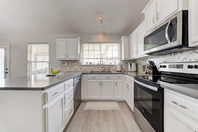 2333 Berry Ln, Midwest City, OK 73130 - kitchen featuring appliances with stainless steel finishes, a sink, a peninsula, and plenty of natural light