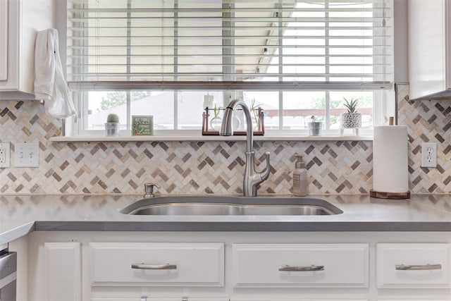 2333 Berry Ln, Midwest City, OK 73130 - kitchen with a sink, white cabinets, and decorative backsplash