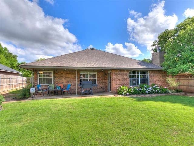 4409 Newport Dr, Norman, OK 73072 - rear view of property featuring brick siding, a chimney, a patio, and roof with shingles