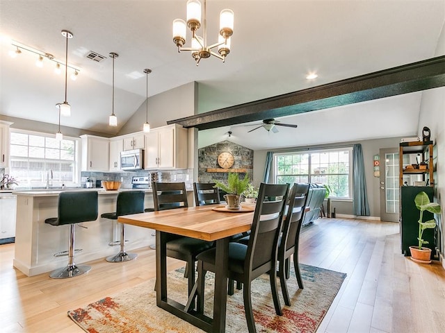 4409 Newport Dr, Norman, OK 73072 - dining area featuring lofted ceiling, healthy amount of natural light, light wood finished floors, a ceiling fan, and a chandelier
