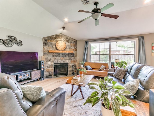 4409 Newport Dr, Norman, OK 73072 - living area featuring vaulted ceiling, wood finished floors, healthy amount of natural light, ceiling fan, and a stone fireplace
