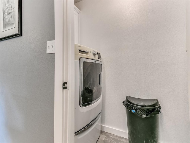 4409 Newport Dr, Norman, OK 73072 - washroom featuring washer / clothes dryer, cabinet space, and baseboards
