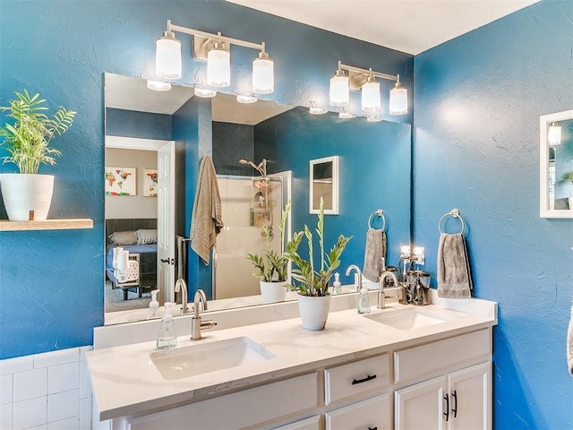 4409 Newport Dr, Norman, OK 73072 - full bath with double vanity, connected bathroom, a shower, and a textured wall