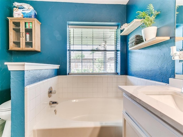 4409 Newport Dr, Norman, OK 73072 - bathroom with a bath, toilet, vanity, and a textured wall