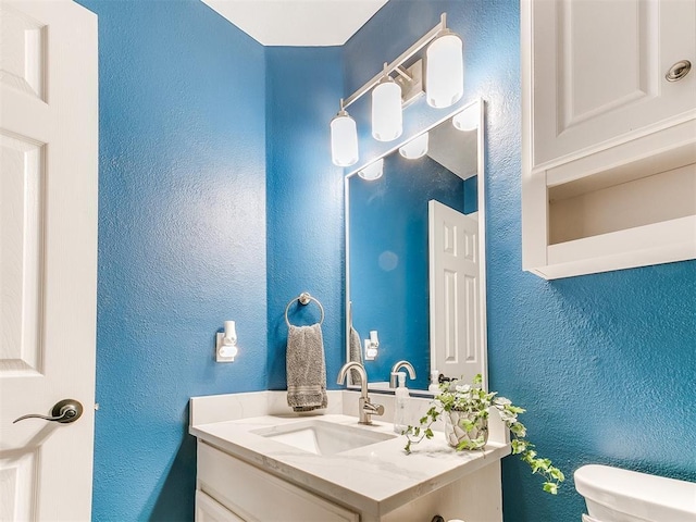 4409 Newport Dr, Norman, OK 73072 - bathroom featuring vanity, toilet, and a textured wall