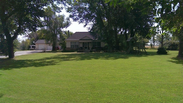 1505 N Piedmont Rd, Yukon, OK 73099 - view of green lawn featuring a playground and driveway