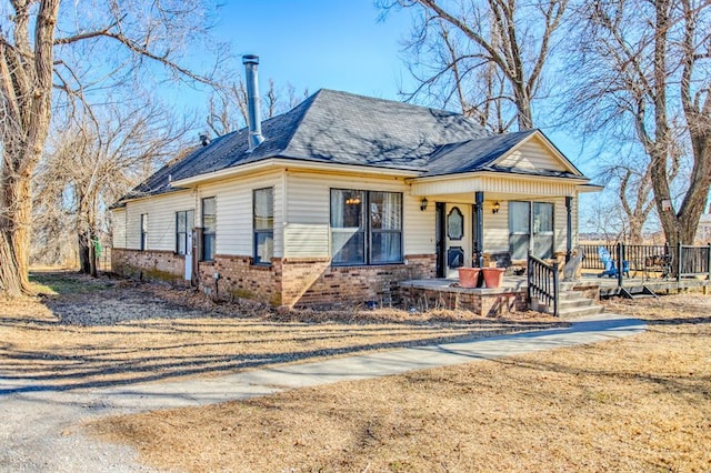 1505 N Piedmont Rd, Yukon, OK 73099 - view of front of home with brick siding, a porch, and roof with shingles