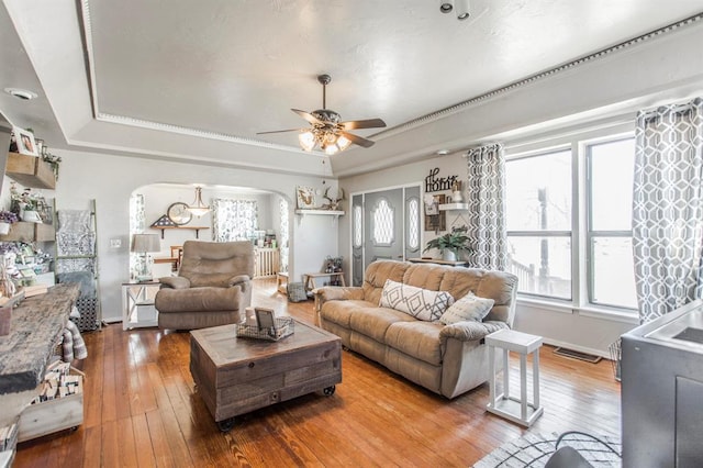 1505 N Piedmont Rd, Yukon, OK 73099 - living area with arched walkways, a raised ceiling, and plenty of natural light