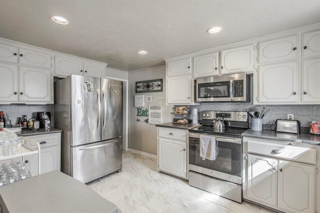 1505 N Piedmont Rd, Yukon, OK 73099 - kitchen featuring stainless steel appliances, white cabinetry, light marble finish flooring, backsplash, and recessed lighting