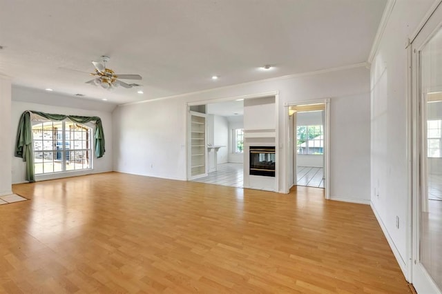 15134 Scottsdale Ln, Choctaw, OK 73020 - unfurnished living room with light wood-type flooring, ceiling fan, ornamental molding, recessed lighting, and a multi sided fireplace