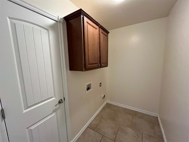 1400 Hillside Ter, Blanchard, OK 73010 - laundry room featuring hookup for a washing machine, cabinet space, baseboards, and light tile patterned floors
