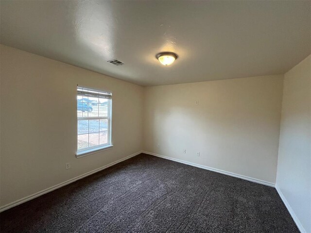 1400 Hillside Ter, Blanchard, OK 73010 - unfurnished room featuring dark colored carpet and baseboards
