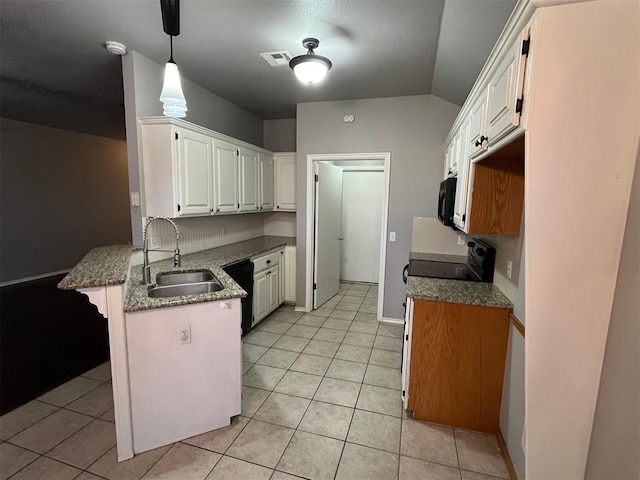 414 SE 7th St, Lexington, OK 73051 - kitchen featuring a sink, a peninsula, black appliances, light tile patterned flooring, and vaulted ceiling