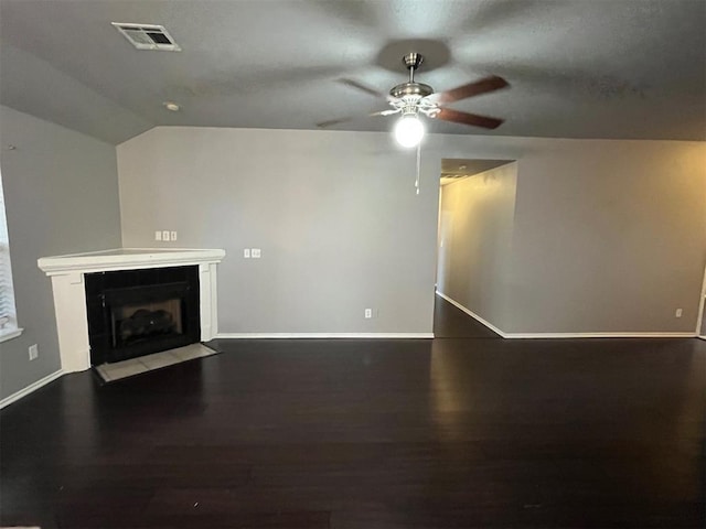 414 SE 7th St, Lexington, OK 73051 - unfurnished living room featuring ceiling fan, baseboards, a fireplace with flush hearth, wood finished floors, and vaulted ceiling