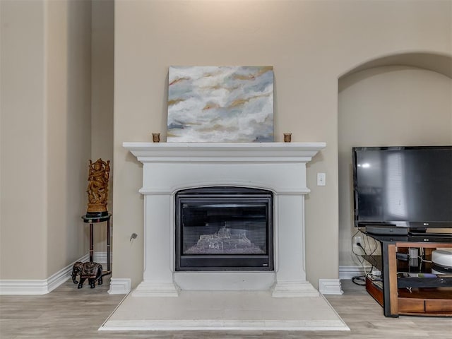 2500 Cordgrass Ln, Edmond, OK 73013 - detailed view of wood finished floors, baseboards, and a glass covered fireplace