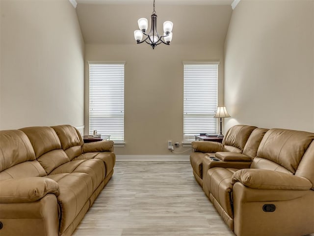 2500 Cordgrass Ln, Edmond, OK 73013 - living area with a chandelier, baseboards, light wood-type flooring, and lofted ceiling