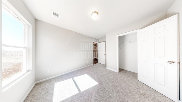 11817 NW 97th St, Yukon, OK 73099 - unfurnished bedroom with carpet, multiple windows, baseboards, and a closet