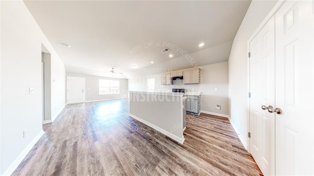 11817 NW 97th St, Yukon, OK 73099 - kitchen featuring wood finished floors, baseboards, a kitchen island, a ceiling fan, and recessed lighting