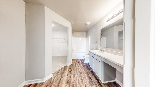 11817 NW 97th St, Yukon, OK 73099 - full bath featuring vanity, toilet, wood finished floors, a spacious closet, and shower / washtub combination
