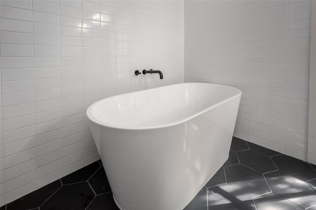 11000 Magnolia Park, Oklahoma City, OK 73120 - bathroom with tile walls, a freestanding bath, and tile patterned floors