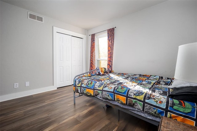11000 Magnolia Park, Oklahoma City, OK 73120 - bedroom featuring wood finished floors, a closet, and baseboards