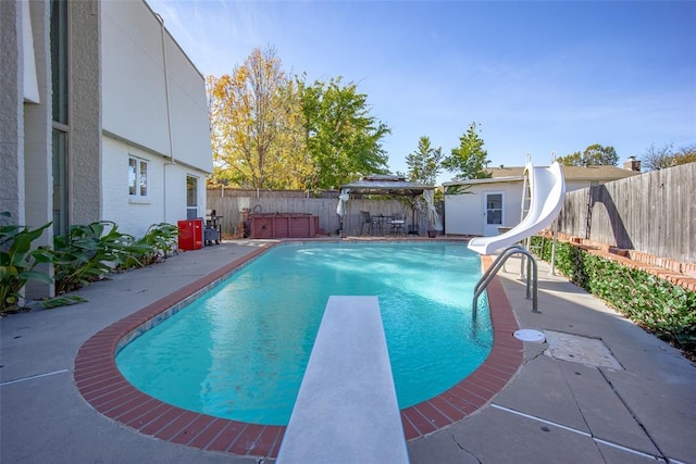 11000 Magnolia Park, Oklahoma City, OK 73120 - view of pool with a jacuzzi, a water slide, a diving board, and a fenced backyard