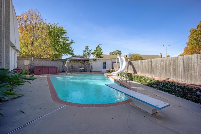 11000 Magnolia Park, Oklahoma City, OK 73120 - view of swimming pool featuring a jacuzzi, a water slide, a fenced backyard, a patio area, and a diving board