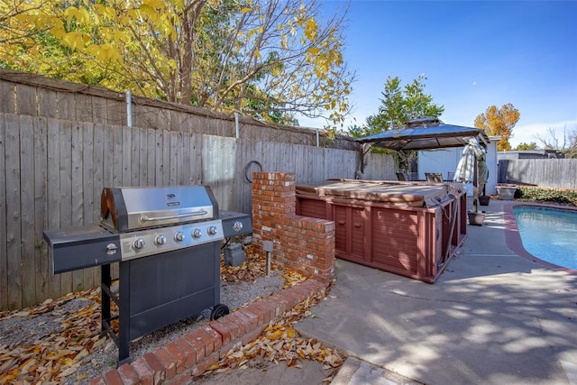 11000 Magnolia Park, Oklahoma City, OK 73120 - fenced backyard featuring a hot tub, a gazebo, a patio, and a grill
