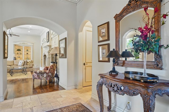 15005 Dourdan Ct, Oklahoma City, OK 73142 - hallway featuring arched walkways, crown molding, baseboards, stone tile floors, and recessed lighting