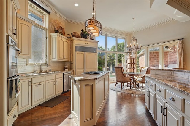 15005 Dourdan Ct, Oklahoma City, OK 73142 - kitchen featuring stainless steel appliances, cream cabinetry, plenty of natural light, a chandelier, and crown molding