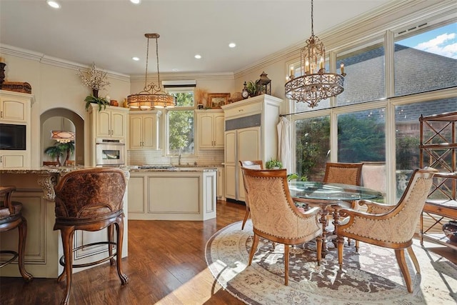 15005 Dourdan Ct, Oklahoma City, OK 73142 - dining room with wood finished floors, a chandelier, ornamental molding, and recessed lighting