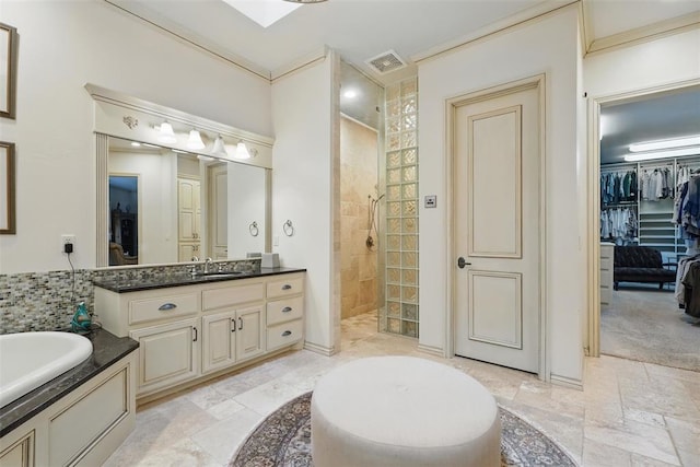 15005 Dourdan Ct, Oklahoma City, OK 73142 - full bath featuring a walk in shower, vanity, a bath, stone tile flooring, and a spacious closet
