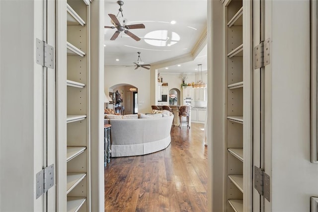 15005 Dourdan Ct, Oklahoma City, OK 73142 - spacious closet featuring arched walkways, a ceiling fan, and wood finished floors