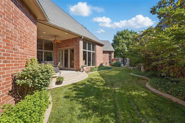 15005 Dourdan Ct, Oklahoma City, OK 73142 - view of green lawn with ceiling fan and a patio area
