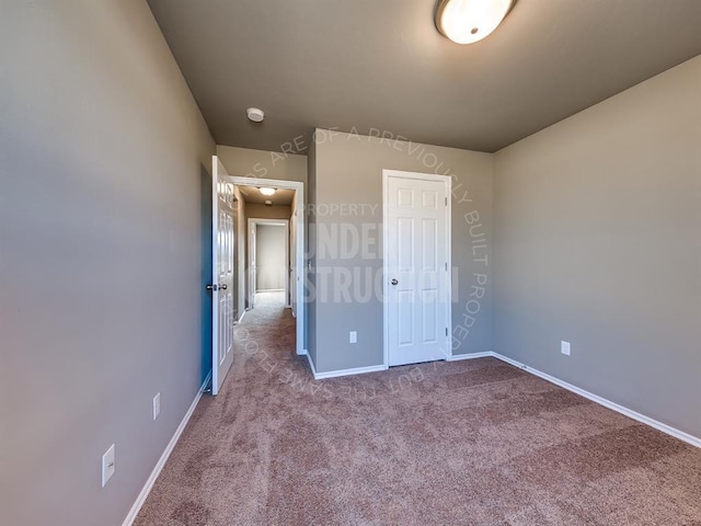 3909 S Ravine St, Stillwater, OK 74074 - unfurnished bedroom featuring baseboards, carpet flooring, and a closet