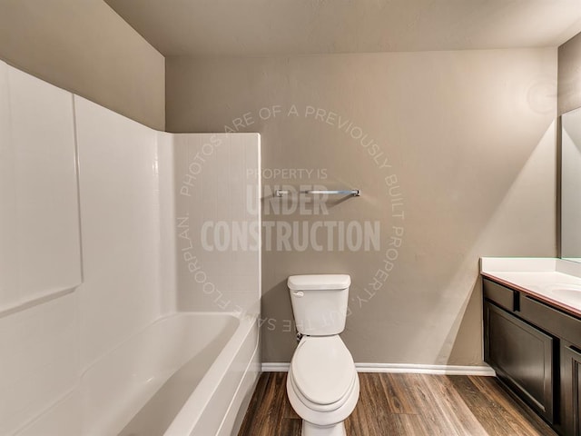 3909 S Ravine St, Stillwater, OK 74074 - full bathroom with wood finished floors, vanity, toilet, bathing tub / shower combination, and baseboards