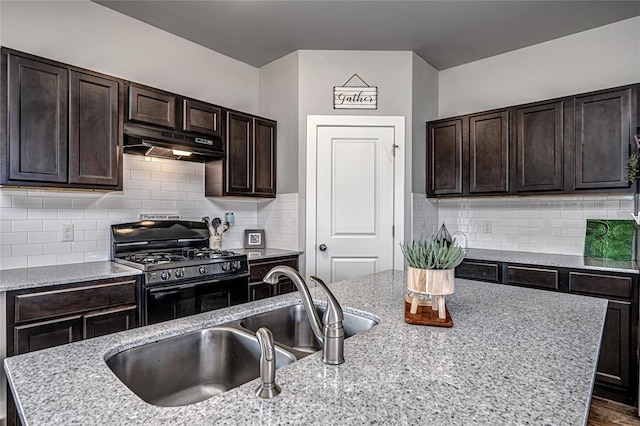 14201 Athens Ln, Yukon, OK 73099 - kitchen featuring under cabinet range hood, black gas range, a sink, and dark brown cabinets