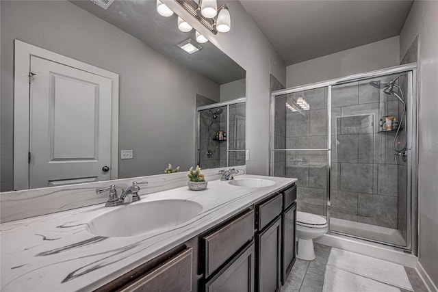14201 Athens Ln, Yukon, OK 73099 - bathroom with toilet, double vanity, a stall shower, and tile patterned flooring