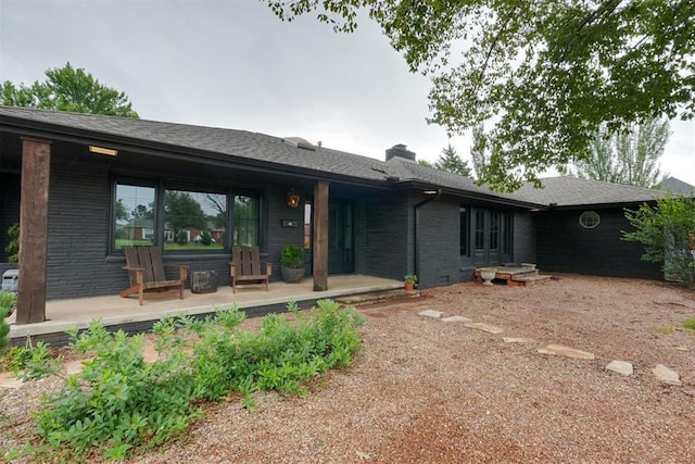 300 E Federal St, Shawnee, OK 74804 - view of front facade featuring brick siding and a chimney