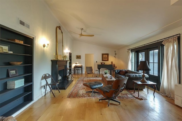 300 E Federal St, Shawnee, OK 74804 - living area featuring hardwood / wood-style floors, a ceiling fan, built in shelves, ornamental molding, and a fireplace with raised hearth