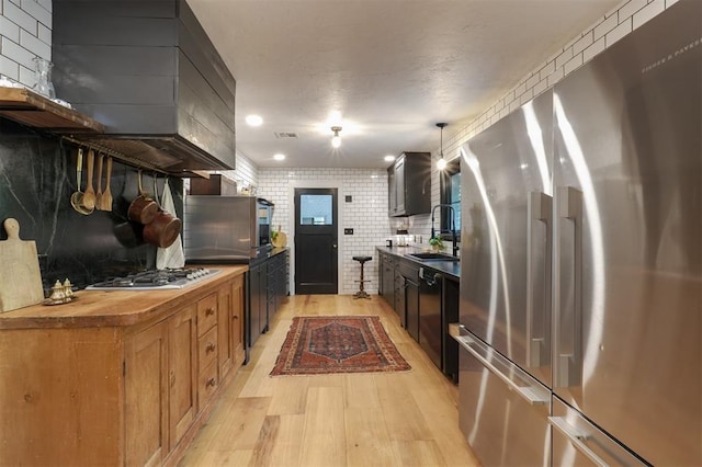 300 E Federal St, Shawnee, OK 74804 - kitchen featuring appliances with stainless steel finishes, a sink, light wood-type flooring, and butcher block counters