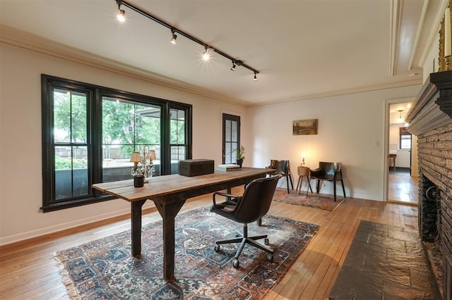 300 E Federal St, Shawnee, OK 74804 - office with track lighting, wood-type flooring, a fireplace, healthy amount of natural light, and crown molding