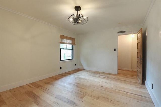 300 E Federal St, Shawnee, OK 74804 - spare room with a chandelier, ornamental molding, light wood finished floors, and baseboards
