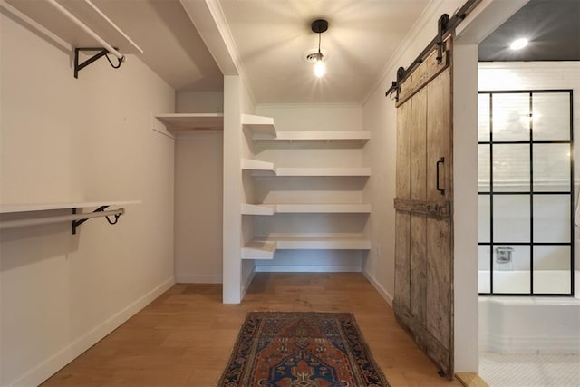 300 E Federal St, Shawnee, OK 74804 - walk in closet featuring a barn door and light wood finished floors