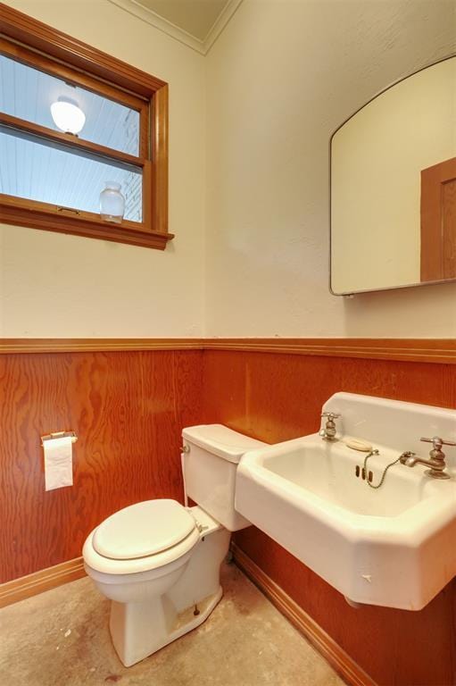 300 E Federal St, Shawnee, OK 74804 - half bathroom featuring toilet, a sink, ornamental molding, and wainscoting