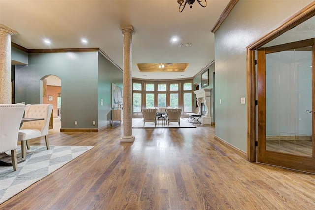 1918 Winding Ridge Rd, Edmond, OK 73034 - living area with ornate columns, crown molding, wood finished floors, recessed lighting, and arched walkways