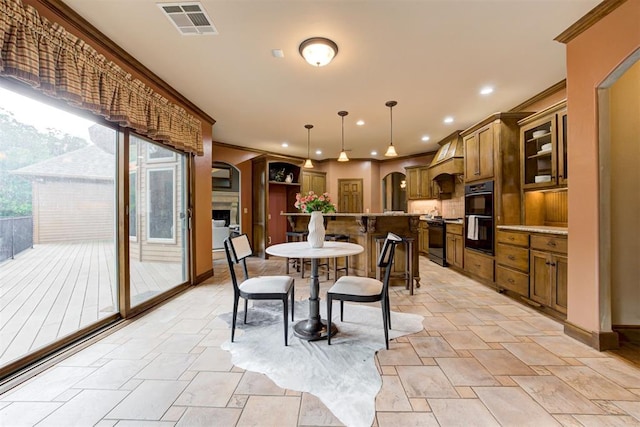 1918 Winding Ridge Rd, Edmond, OK 73034 - dining space featuring arched walkways, stone tile floors, recessed lighting, and crown molding