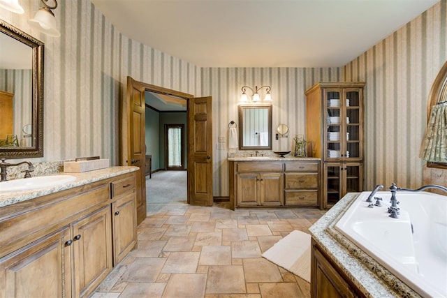 1918 Winding Ridge Rd, Edmond, OK 73034 - full bathroom with wallpapered walls, stone finish flooring, two vanities, and a jetted tub