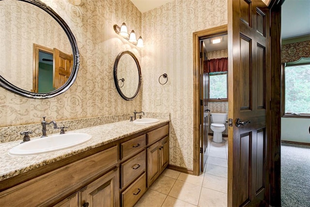1918 Winding Ridge Rd, Edmond, OK 73034 - bathroom with wallpapered walls, double vanity, plenty of natural light, and tile patterned flooring